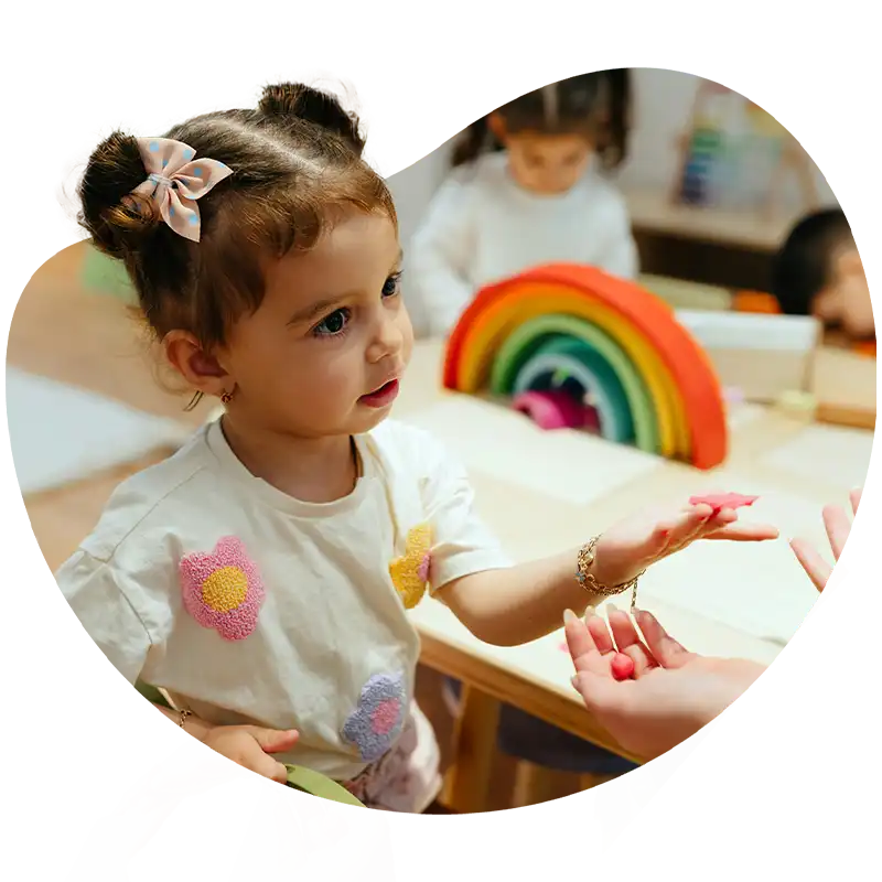 Child learning social and communication skills through natural-environment ABA therapy with family participation in Columbus, GA