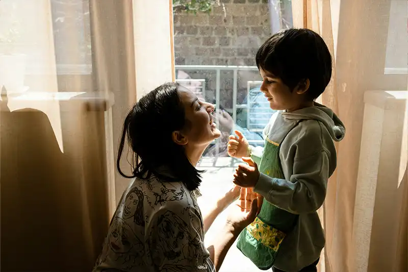 Parent giving child a token during a reward system